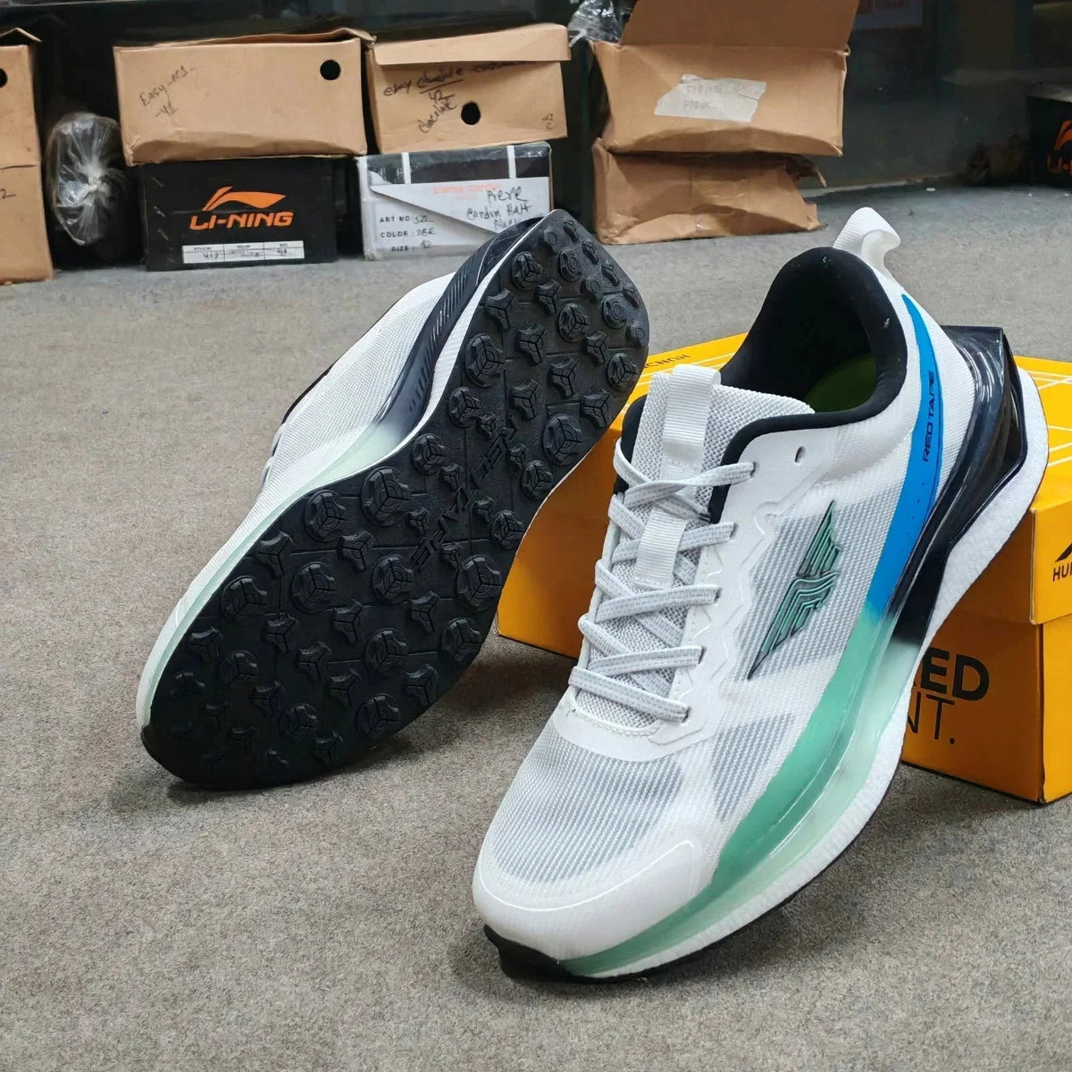 Pair of Redtape white premium running mesh sneakers for men with blue accents.