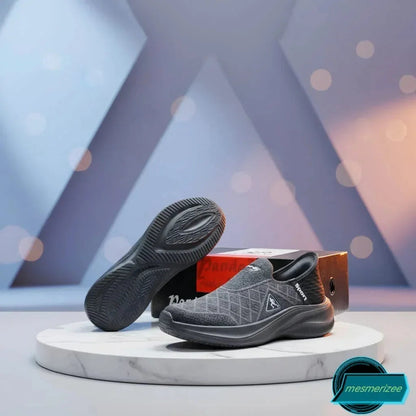 Dark grey premium running mesh sneakers for men by Mesmerizeecom on a marble pedestal