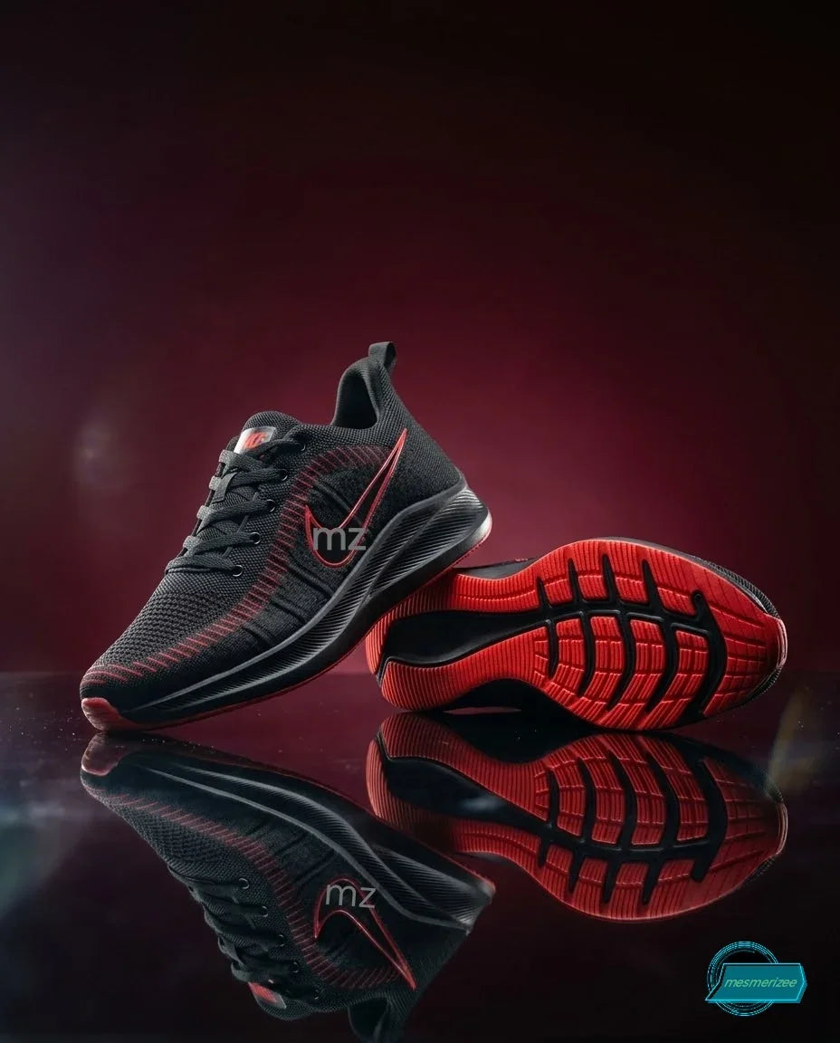 Mesmerizee black and red premium running mesh sneakers for men shown on a reflective surface.
