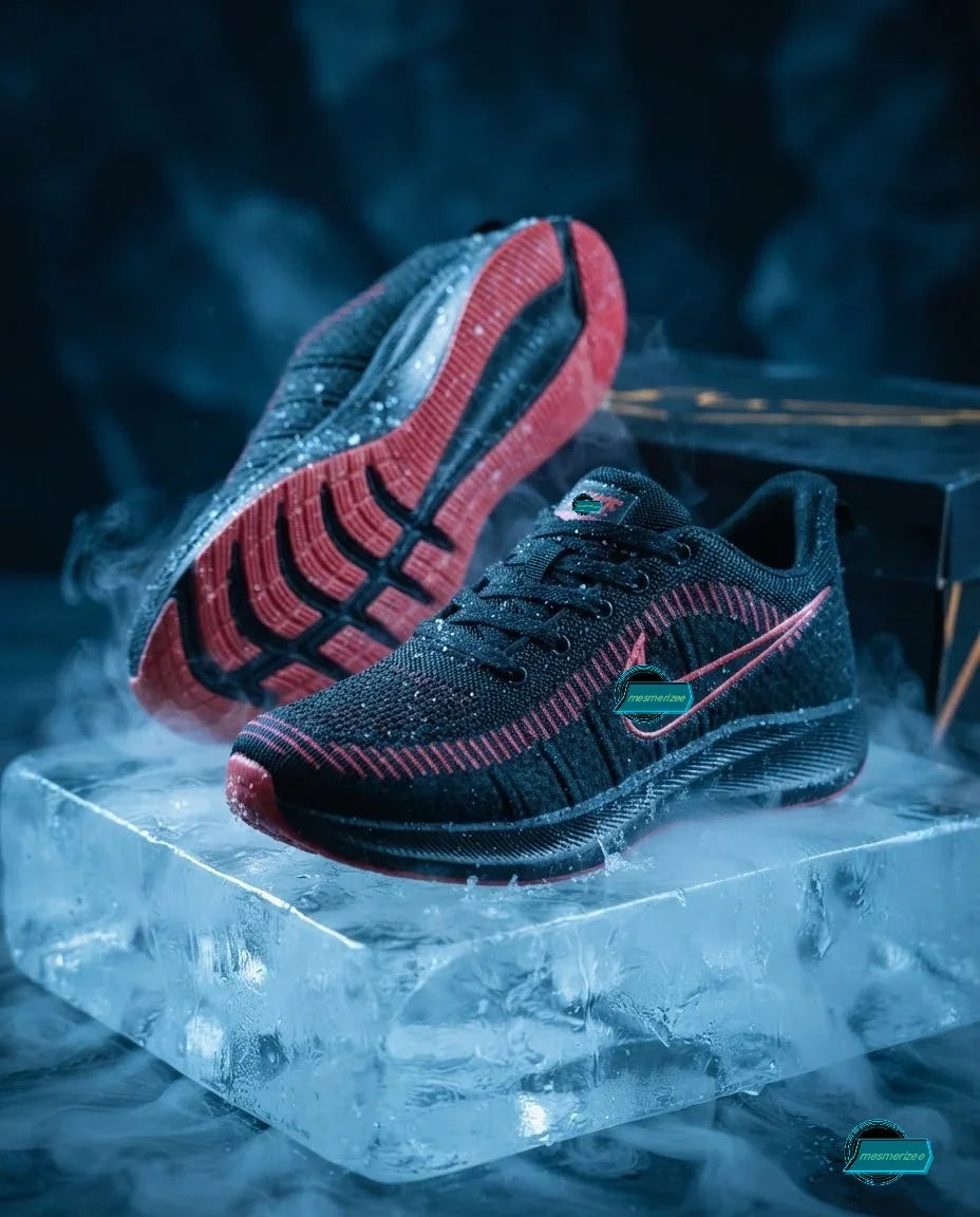 Mesmerizee black premium running mesh sneakers with red soles on ice.